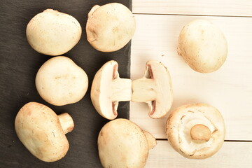 Freshly cut mushrooms, close-up, on a white wooden table.