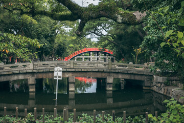 Fototapeta na wymiar Red bridge in beautiful park, city of Osaka Japan.