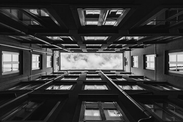 Rectangle sky view from the bottom of the small courtyard between the buildings