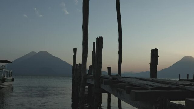 sunset at the atitlan lake pier, with volcano background