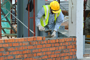 JOHOR, MALAYSIA -APRIL 05, 2016: Bricklayer install clay bricks for building walls.