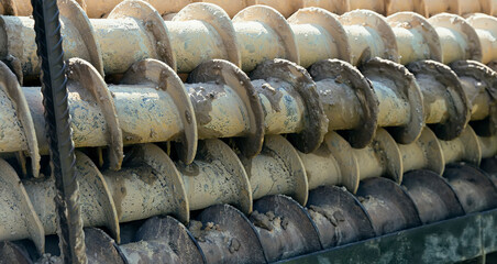 Large drills lie on a machine after drilling a well