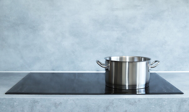 Steel pot on induction cooker. 