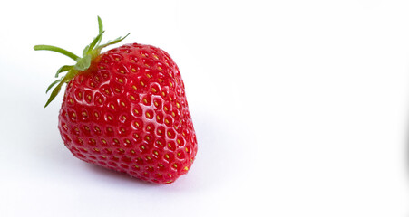 Ripe red strawberry berry closeup on a white background.