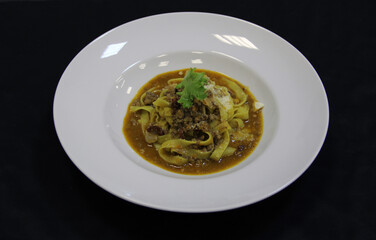 Pasta with nuts on a white plate. Close-up