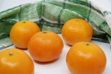 Tangerine or Mandarin. Mandarin isolated on white background. Green kitchen towel