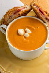 Tomato Soup. Homemade tomato soup topped with feta cheese and paired with mini grilled cheese sandwiches. Traditional classic American lunch favorite. 