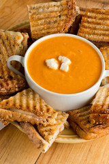 Tomato Soup. Homemade tomato soup topped with feta cheese and paired with mini grilled cheese sandwiches. Traditional classic American lunch favorite. 