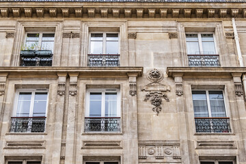 Old French house with traditional balconies and windows. Paris, France.