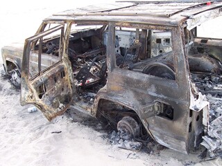 Fototapeta premium Burned up abandoned car on the beach in Cabo San Lucas Mexico 2006