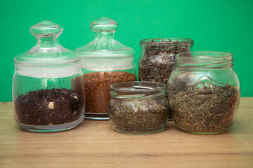 Assortment of tee and coffee in glass jars on wooden table. zero waste concept.