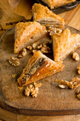 Fototapeta premium Baklava. A classic traditional rich and sweet mediterranean, Greek or Turkish, dessert pastry made of layers of filo filled with chopped nuts and sweetened and held together with syrup or honey.