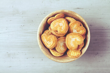 Homemade heart shaped sugar biscuit in wooden bowl