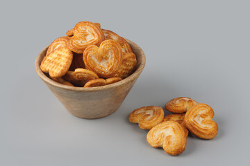 Homemade heart shaped sugar biscuit in wooden bowl