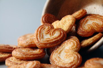 Homemade heart shaped sugar biscuit in wooden bowl