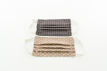 2 selbstgenähte Alltagsmasken in hell- und dunkelbraun, gblümt und karriert