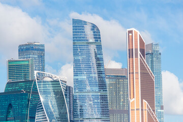 Fototapeta na wymiar Cityscape of Moscow city with skyscrapers of Moscow International Business Center (MIBC). Blue sky with few clouds on a summer morning. Modern office buildings theme.