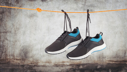 Men's Sport shoes hanging on rope