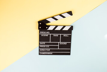 Cinema clapperboard on yellow blue colorful background - Movie cinema entertainment concept