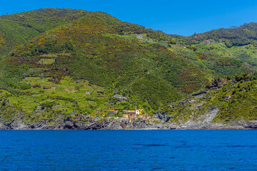 The Cinque Terre village of Vernazza beneath the commanding cliffs in summertime