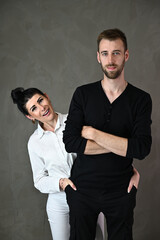 Studio portrait of a caucasian brunette woman and a man in a love relationship with a smile and happiness