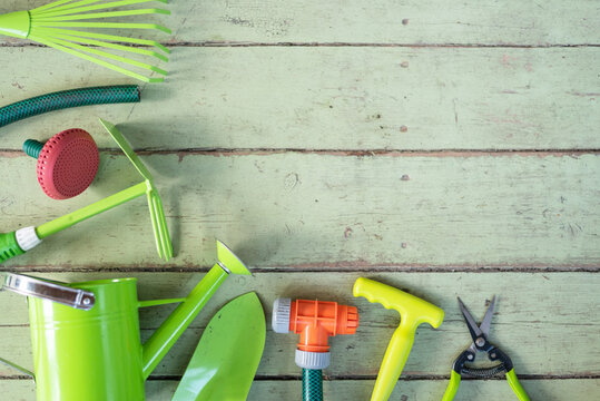 Garden tools on the old green wooden floor background with copy space.