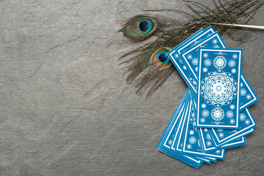Blue tarot cards on the stone table surface background.