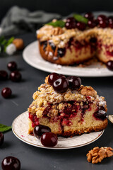 Piece homemade cherry pie with shtreisel and walnuts on white plate on a dark concrete background, Closeup