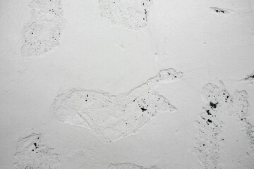 A ragged brick wall. Peeling putty, cement, paint. Unloaded wall, preparation for repair. Texture, cracked, chipped.