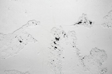 A ragged brick wall. Peeling putty, cement, paint. Unloaded wall, preparation for repair. Texture, cracked, chipped.