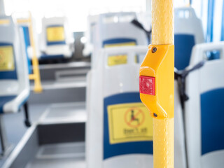 Bus stop button for getting off inside bus. Seat on bus with no sitting sign. Coronavirus, covid19 pandemic outbreak.