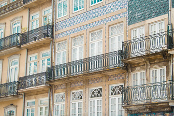 Beautiful typical Portuguese facade of majestic residential building with blue tiles and white windows on elegant balconies in the center of Porto Portugal