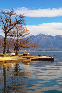 Beautiful winter Mediterranean landscape. Montenegro, Herceg Novi. View of Kotor Bay near Djenovici village and snow-capped Lovcen mountain