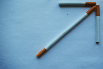 Cigarettes in the shape of arrows on a gradient background..