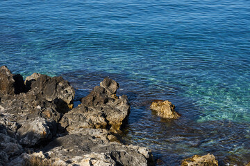 Rocky sea coast of Kolimvari in Crete Greece with turquoise water as a natural background. Copy space.