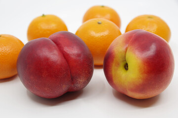 Fototapeta na wymiar Nectarines and mandarins isolated on white background.