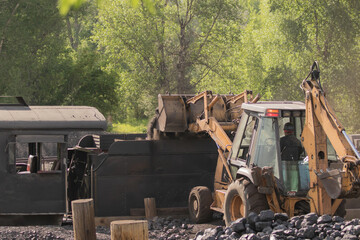 Loading an old train car with a front end loader 