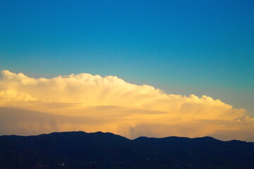 nice landscape with illuminated white clouds on blue sky background