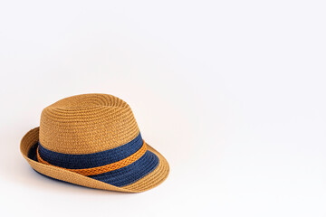 Straw hat on white background with copy space.