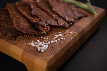 Close-up of a piece of meat on a wooden Board with spices. Restaurant menu, a series of photos of different dishes