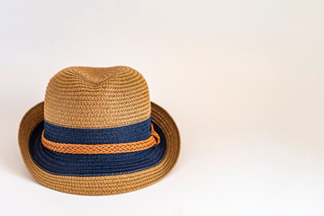 Straw hat on white background with copy space.