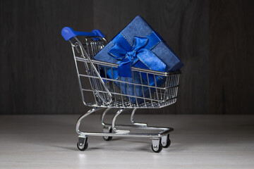 Shopping carts with gifts inside on a dark background.