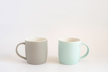 Two mugs on white background with copy space.