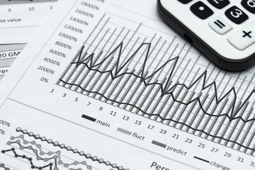 business office desk closeup - financial reports, analysis and accounting, set of documents, tables and graphs, various items for bookkeeping, calculator