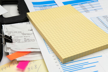 business office desk closeup - financial reports, analysis and accounting, set of documents, tables and graphs, various items for bookkeeping, calculator