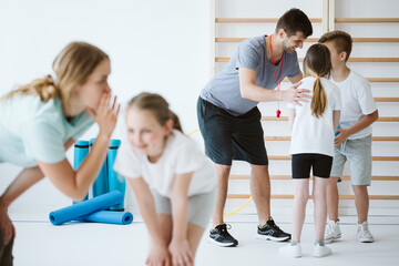 Kids exercising during physical education at school gym