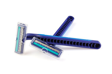 Two blue plastic razors and a shaving blade isolated on a white background. New disposable razor blade. Close-up. Full depth of field.
