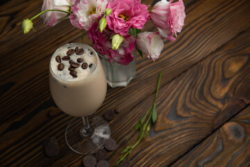Coffee drink frappe. On a brown wooden table.
