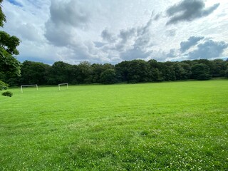 Football pitch, with a large field and trees nearby in, Northcliffe Park, Bradford, UK