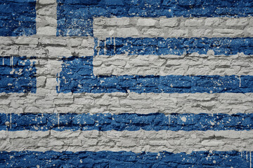 Fototapeta na wymiar painted big national flag of greece on a massive old brick wall